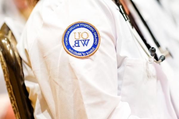 A close-up of the OUWB patch on a white coat. 